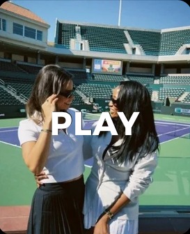 Two guests talking on a stadium tennis court