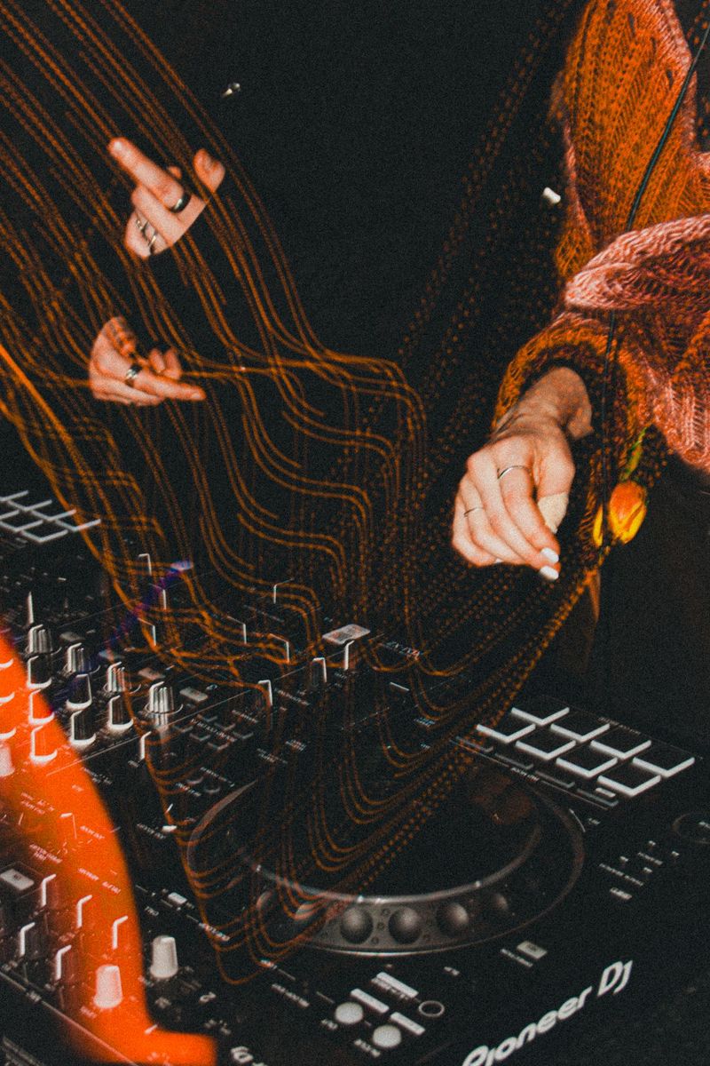 DJ hands over Pioneer decks with light trails in a dark club